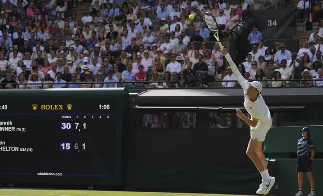 Jannik Sinner of Italy serves the ball to Ben Shelton of the U.S. during the men's singles quarter final match at the Wimbledon Tennis Championships in London, Wednesday, July 9, 2025.(AP Photo/Kirsty Wigglesworth)
