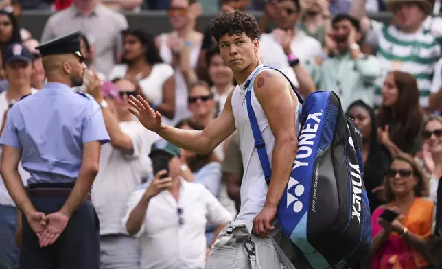 Ben Shelton of the U.S. leaves court after losing the men's singles quarter final match against Jannik Sinner of Italy at the Wimbledon Tennis Championships in London, Wednesday, July 9, 2025.(AP Photo/Kirsty Wigglesworth)