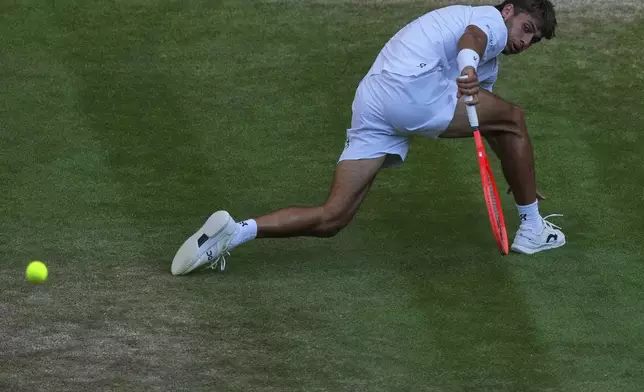 Italy's Flavio Cobolli returns to Serbia's Novak Djokovic during a quarterfinal men's singles match at the Wimbledon Tennis Championships in London, Wednesday, July 9, 2025. (AP Photo/Joanna Chan)