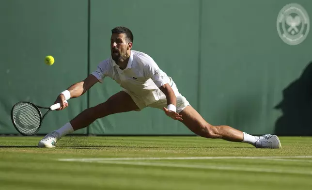 Serbia's Novak Djokovic returns to Italy's Flavio Cobolli during a quarterfinal men's singles match at the Wimbledon Tennis Championships in London, Wednesday, July 9, 2025. (AP Photo/Kin Cheung)
