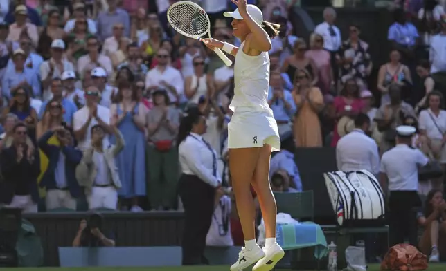 Iga Swiatek of Poland celebrates winning the women's singles semifinal match against Belinda Bencic of Switzerland at the Wimbledon Tennis Championships in London, Thursday, July 10, 2025.(AP Photo/Kirsty Wigglesworth)