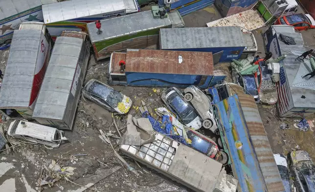 Damaged vehicles are seen after severe monsoon rains flooded the Bhotekoshi River and swept away a key bridge connecting the country with China at Rasuwagadi,120 kilometers (75 miles) north of the capital, Kathmandu, Nepal, Wednesday, July, 9, 2025. (AP Photo/Sujan Gurung)