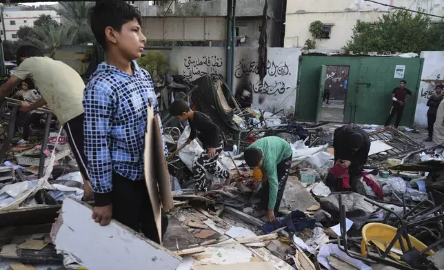 FILE - Palestinians inspect the damage to a school that was hit in a deadly Israeli military strike in Gaza City on May 26, 2025. (AP Photo/Jehad Alshrafi, File)