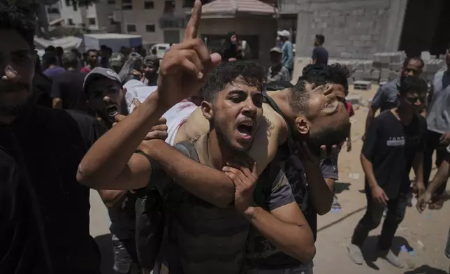 The bodies of Palestinians killed while trying to reach aid trucks entering northern Gaza through the Zikim crossing with Israel, are brought to Shifa Hospital in Gaza City on Sunday, July 20, 2025. (AP Photo/Jehad Alshrafi)