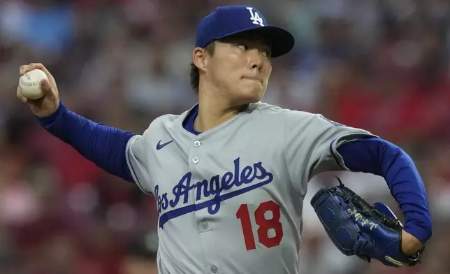 Los Angeles Dodgers pitcher Yoshinobu Yamamoto throws during the first inning of a baseball game against the Cincinnati Reds, Monday, July 28, 2025, in Cincinnati. (AP Photo/Carolyn Kaster)