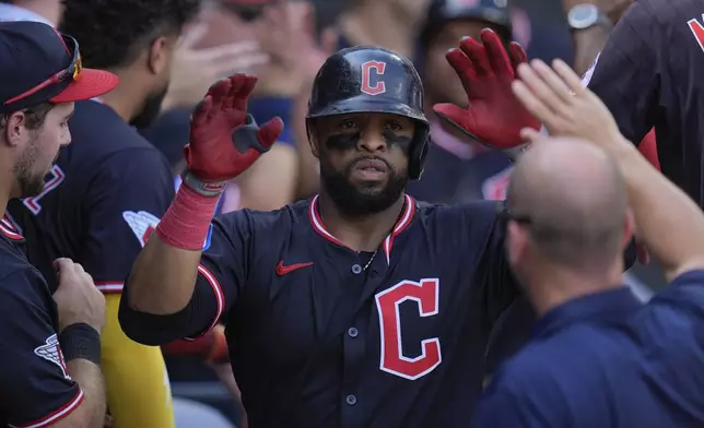 Cleveland Guardians' Carlos Santana celebrates after hitting a two-run home run during the sixth inning of the first baseball game of a doubleheader against the Chicago White Sox, Friday, July 11, 2025, in Chicago. (AP Photo/Erin Hooley)