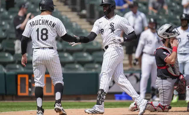 Chicago White Sox's Luis Robert Jr., right, celebrates with Mike Tauchman (18) after hitting a two-run home run during the second inning of the first baseball game of a doubleheader against the Cleveland Guardians, Friday, July 11, 2025, in Chicago. (AP Photo/Erin Hooley)