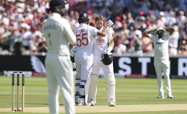 England's captain Ben Stokes, second left, congratulates Joe Root after scoring a century during the third cricket test match between England and India at Lord's cricket ground in London, Friday, July 11, 2025. (AP Photo/Richard Pelham)