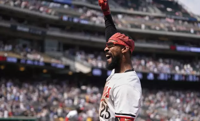 Minnesota Twins' Byron Buxton (25) acknowledges the crowd during a curtain call after hitting a solo home run for the cycle during the seventh inning of a baseball game against the Pittsburgh Pirates, Saturday, July 12, 2025, in Minneapolis. (AP Photo/Abbie Parr)