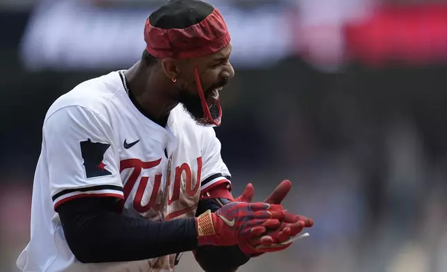 Minnesota Twins' Byron Buxton (25) celebrates after hitting a triple during the second inning of a baseball game against the Pittsburgh Pirates, Saturday, July 12, 2025, in Minneapolis. (AP Photo/Abbie Parr)