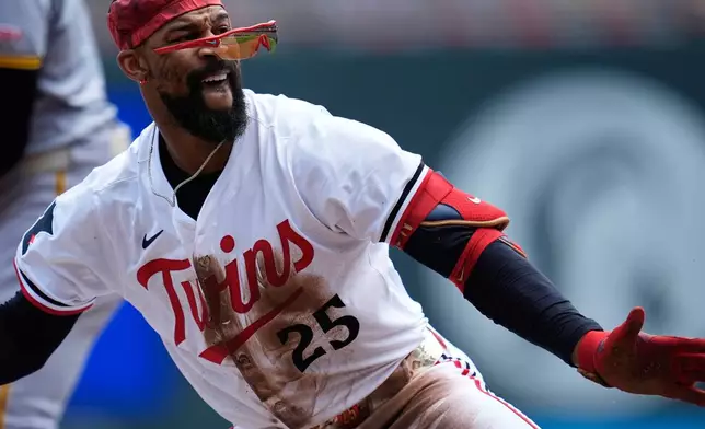 Minnesota Twins' Byron Buxton (25) celebrates after hitting a triple during the second inning of a baseball game against the Pittsburgh Pirates, Saturday, July 12, 2025, in Minneapolis. (AP Photo/Abbie Parr)