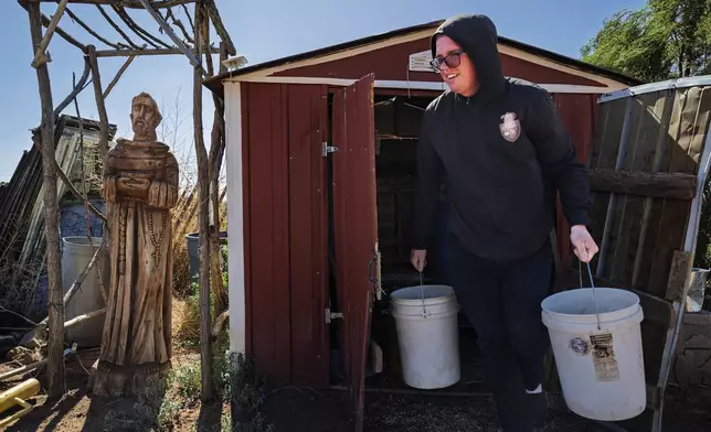 League of the Blessed Sacrament member Edward Seeley steps out of a shed as he prepares to feed horses at the lay group’s animal farm, in Concho, Ariz., Saturday, June 21, 2025. (AP Photo/Roberto E. Rosales)