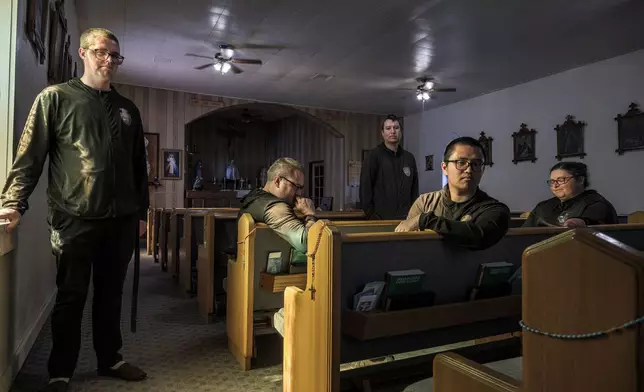 League of the Blessed Sacrament members Edward Seeley, from left to right, Eric Faris, Giovanni Vizcarra, Anthony Ribaya and Lisa Hezmalhalch, gather inside the San Rafael parish church in Concho, Ariz., Saturday, June 21, 2025. Bishop James S. Wall has ordered the lay group of young Catholics to leave parish housing and stop leading liturgy and teaching in the region’s Catholic school. (AP Photo/Roberto E. Rosales)