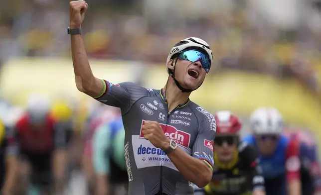 Netherlands' Mathieu van der Poel celebrates as he crosses the finish line to win the second stage of the Tour de France cycling race over 209.1 kilometers (129.9 miles) with start in Lauwin-Planque and finish in Boulogne-sur-Mer, France, Sunday, July 6, 2025. (AP Photo/Mosa'ab Elshamy)
