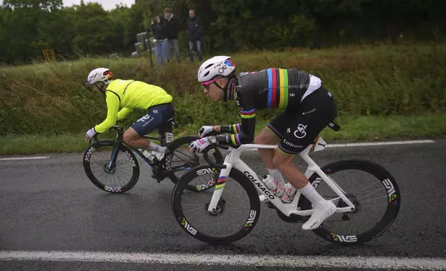France's Mathieu Burgaudeau, left, and Slovenia's Tadej Pogacar ride during the second stage of the Tour de France cycling race over 209.1 kilometers (129.9 miles) with start in Lauwin-Planque and finish in Boulogne-sur-Mer, France, Sunday, July 6, 2025. (AP Photo/Thibault Camus)