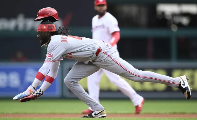 Cincinnati Reds' Elly De La Cruz starts his slide as he steals second base during the fourth inning of a baseball game against the Washington Nationals, Wednesday, July 23, 2025, in Washington. (AP Photo/Nick Wass)