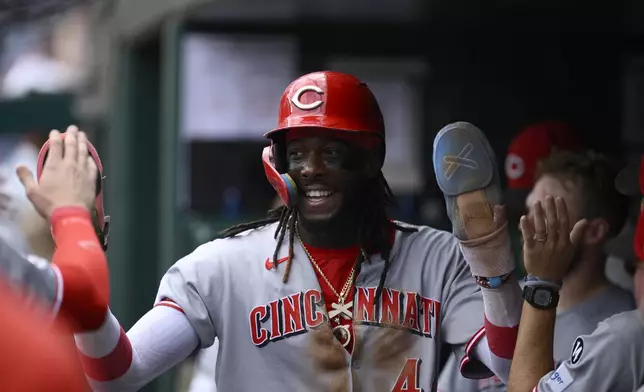 Cincinnati Reds' Elly De La Cruz celebrates in the dugout after he scored on single by Jake Fraley during the fourth inning of a baseball game against the Washington Nationals, Wednesday, July 23, 2025, in Washington. (AP Photo/Nick Wass)