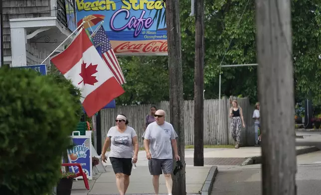 FILE - A Canadian flag flies outside a shop, Thursday, July 1, 2021, in Old Orchard Beach, Maine. (AP Photo/Robert F. Bukaty, File)