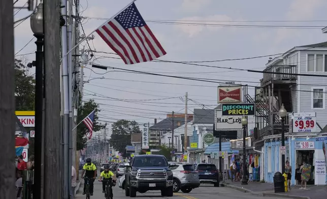 Community Service Officers from the Old Orchard Beach Police Dept. patrol on bicycles, Tuesday, July 29, 2025, in Old Orchard Beach, Maine. (AP Photo/Robert F. Bukaty)