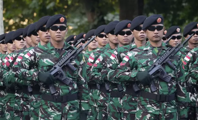 Indonesian troops march during a rehearsal for the upcoming Bastille Day parade, Wednesday, July 9, 2025 on the Champs-Elysees avenue in Paris. (AP Photo/Michel Euler)