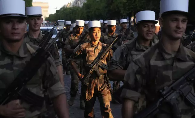 Foreign Legion soldiers arrive for a rehearsal for the upcoming Bastille Day parade, Wednesday, July 9, 2025 on the Champs-Elysees avenue in Paris. (AP Photo/Michel Euler)