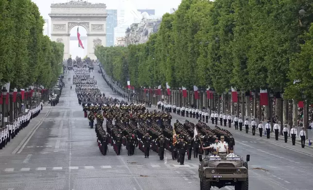 French troops march on the Champs-Elysees avenue during the Bastille Day parade, Monday, July 14, 2025 in Paris. (AP Photo/Christophe Ena)