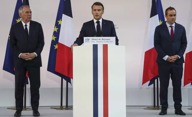 French President Emmanuel Macron speaks to the army leaders flanked by Prime Minister Francois Bayrou, left, and Defense Minister Sebastien Lecornu at the Hotel le Brienne, Sunday, July 13, 2025, ahead of the Bastille Day parade in Paris. (Ludovic Marin, Pool Photo via AP)