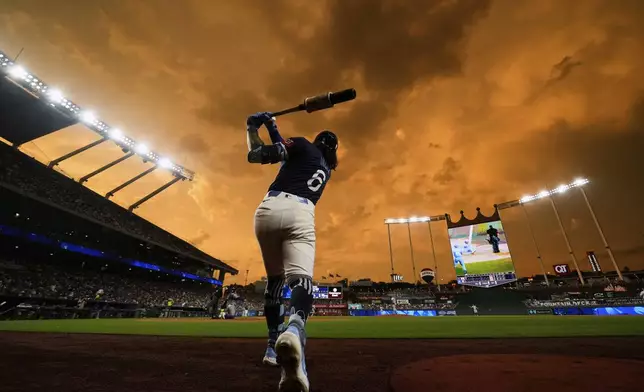 Kansas City Royals' Jonathan India warms up on deck during the first inning of a baseball game against the New York Mets, Friday, July 11, 2025, in Kansas City, Mo. (AP Photo/Charlie Riedel)