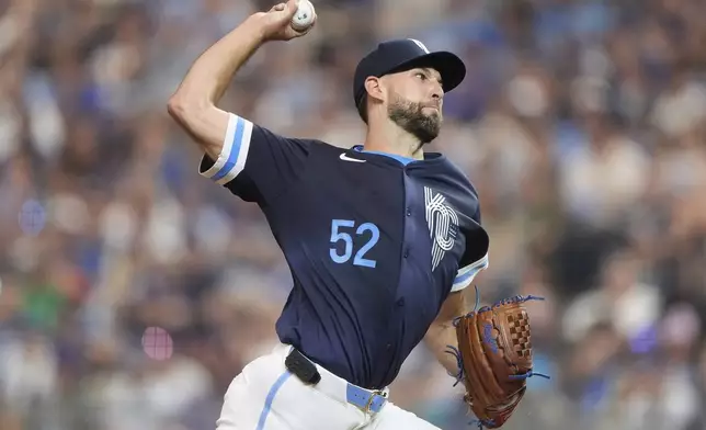 Kansas City Royals starting pitcher Michael Wacha throws during the first inning of a baseball game against the New York Mets, Friday, July 11, 2025, in Kansas City, Mo. (AP Photo/Charlie Riedel)