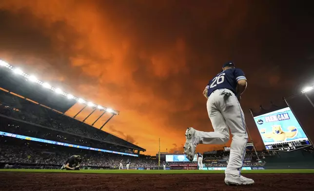 Kansas City Royals left fielder John Rave runs onto the field during the first inning of a baseball game against the New York Mets, Friday, July 11, 2025, in Kansas City, Mo. (AP Photo/Charlie Riedel)