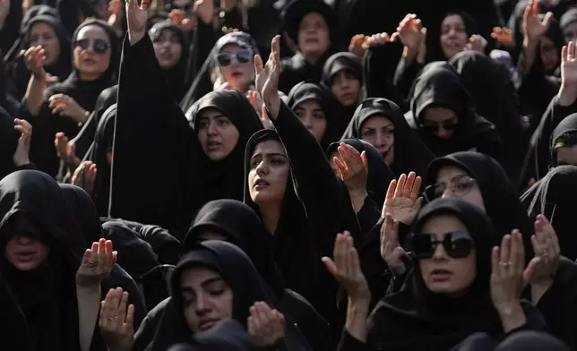 Iranian Shiite Muslims pray in a mourning ceremony in Tehran, Iran, Friday, July 4, 2025, ahead of Ashoura, a remembrance of the 7th-century martyrdom of the Prophet Muhammad's grandson, Hussein, who was killed in a battle in Karbala in present-day Iraq. (AP Photo/Vahid Salemi)