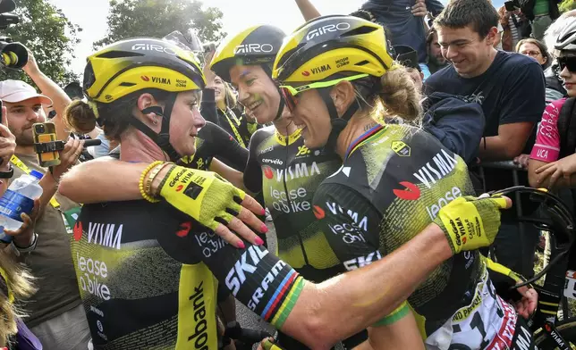 Stage winner Netherland's Marianne Vos, left, is congratulared by teammate Freance's Pauline Ferrand-Prevot, right, after the first stage of the Women's Tour de France cycling race which starts in Vannes and finishes in Plumelec, Saturday, July 26, 2025 in Plumelec, Brittany, western France. (AP Photo/Mathieu Pattier)