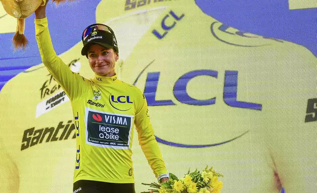 Netherland's Marianne Vos wears the overall leader's yellow jersey after the first stage of the Women's Tour de France cycling race which starts in Vannes and finishes in Plumelec, Saturday, July 26, 2025 in Plumelec, Brittany, western France. (AP Photo/Mathieu Pattier)