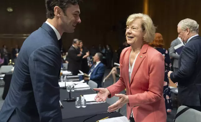 Sens. Jon Ossoff, D-Ga., left, and Sen. Tammy Baldwin, D-Wis., talk before the start of the Senate Appropriations full committee markup of commerce, justice, science, agriculture, rural development, FDA, the Legislative Branch Appropriations Acts and other bills on Capitol Hill in Washington, Thursday, July 10, 2025. (AP Photo/Manuel Balce Ceneta)