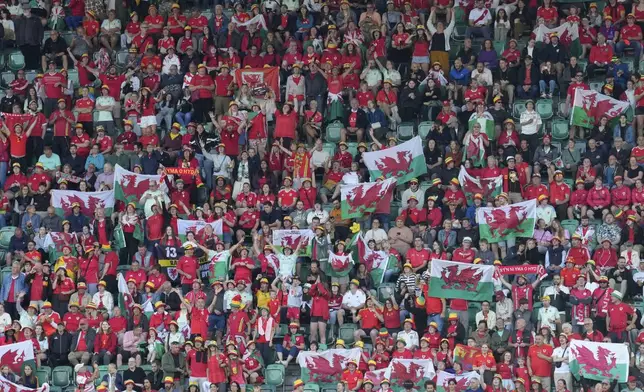 Fans of Wales cheer prior the Euro 2025, group D, soccer match between France and Wales at Arena St. Gallen in St. Gallen, Switzerland, Wednesday, July 9, 2025. (AP Photo/Martin Meissner)