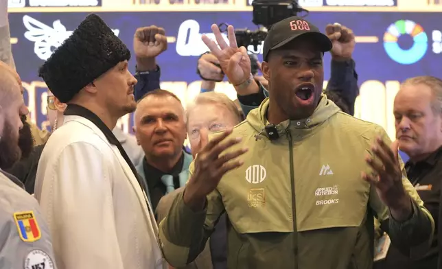 Ukraine's boxer Oleksandr Usyk, left, and Britain's Daniel Dubois attend a press conference in Wembley stadium in London, Thursday, July 17, 2025, ahead of their boxing fight on Saturday. (AP Photo/Kin Cheung)