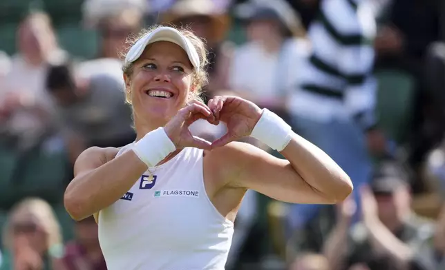 Laura Siegmund of Germany celebrates winning her women's singles fourth round match against Solana Sierra of Argentina at the Wimbledon Tennis Championships in London, Sunday, July 6, 2025.(AP Photo/Kirsty Wigglesworth)