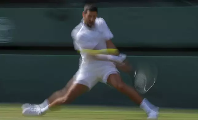 Serbia's Novak Djokovic returns to Australia's Alex de Minaur during a fourth round men's singles match at the Wimbledon Tennis Championships in London, Monday, July 7, 2025. (AP Photo/Kin Cheung)