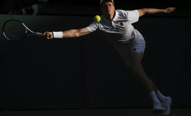 Italy's Jannik Sinner returns to Bulgaria's Grigor Dimitrov during a fourth round men's singles match at the Wimbledon Tennis Championships in London, Monday, July 7, 2025. (AP Photo/Kin Cheung)