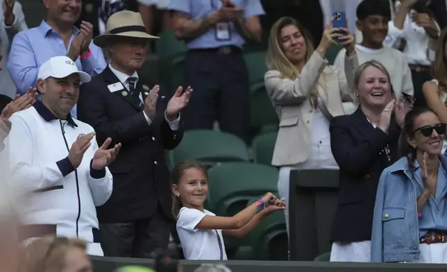 Tara, the daughter of Novak Djokovic of Serbia does a dance as she celebrates her father beating Miomir Kecmanovic of Serbia during a third round men's singles match at the Wimbledon Tennis Championships in London, Saturday, July 5, 2025. (AP Photo/Kirsty Wigglesworth)