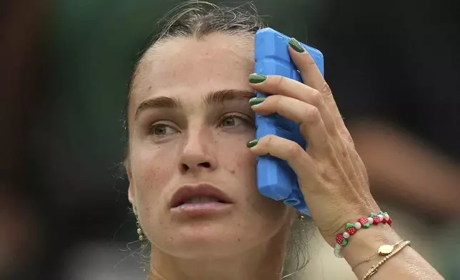 Aryna Sabalenka of Belarus uses an ice pack to keep cool during a change of ends break as she plays Belgium's Elise Mertens during a fourth round women's singles match at the Wimbledon Tennis Championships in London, Sunday, July 6, 2025. (AP Photo/Alastair Grant)