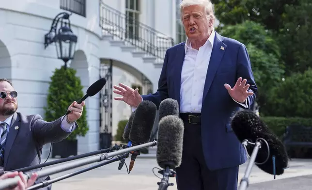 President Donald Trump speaks with reporters before departing the White House, Friday, July 11, 2025, in Washington. (AP Photo/Evan Vucci)