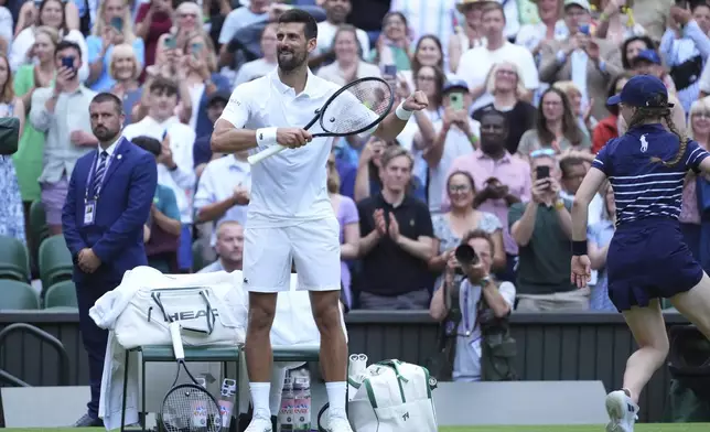 Novak Djokovic of Serbia does a dance as he celebrates beating Miomir Kecmanovic of Serbia during a third round men's singles match at the Wimbledon Tennis Championships in London, Saturday, July 5, 2025. (AP Photo/Kirsty Wigglesworth)