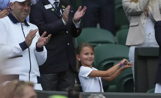 Tara, the daughter of Novak Djokovic of Serbia does a dance as she celebrates her father beating Miomir Kecmanovic of Serbia during a third round men's singles match at the Wimbledon Tennis Championships in London, Saturday, July 5, 2025. (AP Photo/Kirsty Wigglesworth)