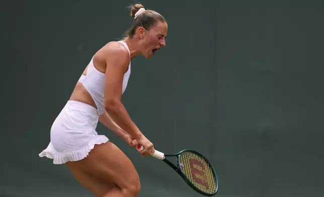 Marta Kostyuk of Ukraine celebrates winning a point against Veronika Erjavec of Slovenia during their first round women's singles match at the Wimbledon Tennis Championships in London, Tuesday, July 1, 2025.(AP Photo/Kirsty Wigglesworth)