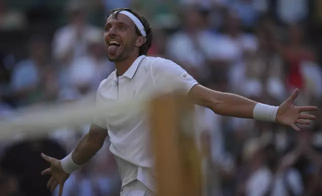 Arthur Rinderknech of France celebrates after beating Alexander Zverev of Germany in their first round men's singles match at the Wimbledon Tennis Championships in London, Tuesday, July 1, 2025. (AP Photo/Kin Cheung)