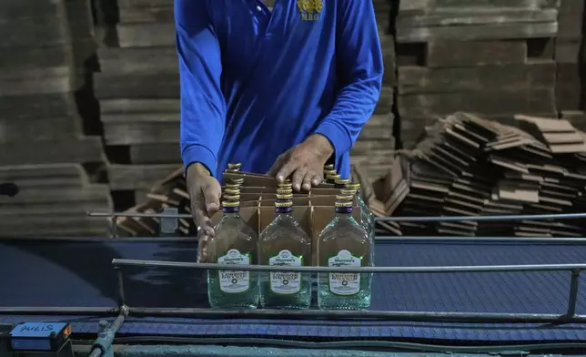 An employee of the Murree Brewery packs liquor bottles at a production unit of the factory, in Rawalpindi, Pakistan, Monday, June 23, 2025. (AP Photo/Anjum Naveed)