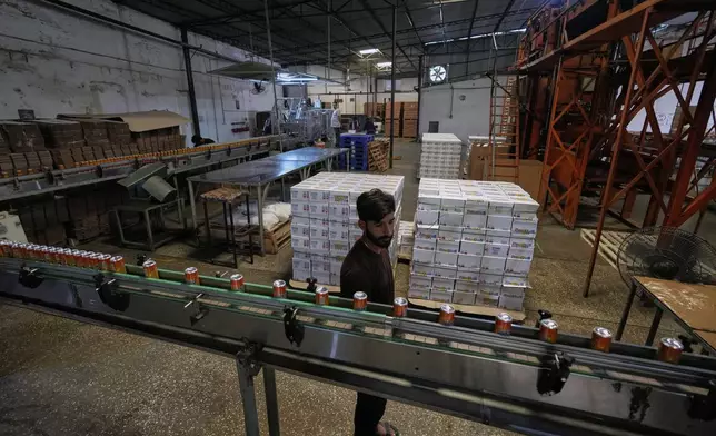 Employees of the Murree Brewery work at a soft drink production unit of the factory, in Rawalpindi, Pakistan, Monday, June 23, 2025. (AP Photo/Anjum Naveed)
