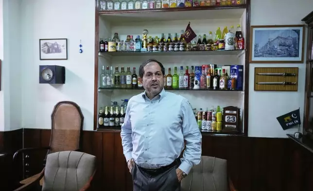 Isphanyar Bandhara, Chief Executive of the Murree Brewery talks with his assistant after an interview with The Associated Press, in Rawalpindi, Pakistan, Monday, June 23, 2025. (AP Photo/Anjum Naveed)