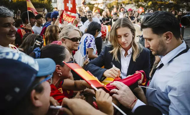 Spain's Alexia Putellas of the women's national football team signs autographs for her fans at the Royal Savoy hotel in Lausanne, Switzerland, on the sidelines of the UEFA Women's Euro 2025, Sunday, June 29, 2025. (Gabriel Monnet/Keystone via AP)